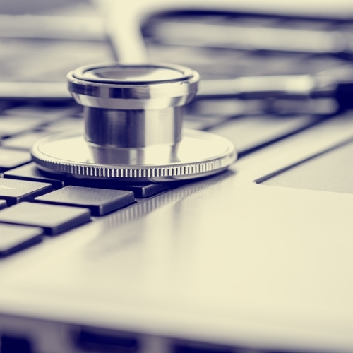 Doctor's hand on a tablet with icons showing